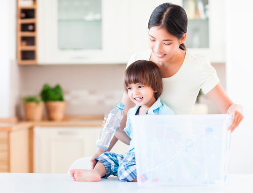 A caring mother teaching her child about the importance of recycling.