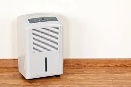 Dehumidifier sitting on a wood floor