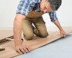 Carpenter installing bamboo flooring in a home