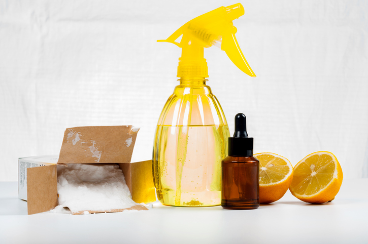 Eco-friendly natural cleaning supplies made of lemon and baking soda on white wooden table