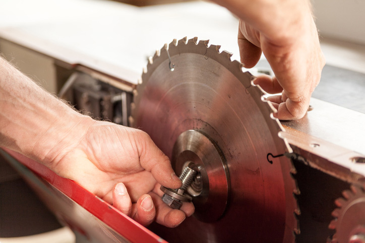 woodworker changing a saw blade to cut bamboo flooring