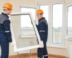 two windows installation workers installing double-glass pane