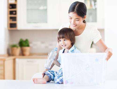 A caring mother teaching her child about the importance of recycling.