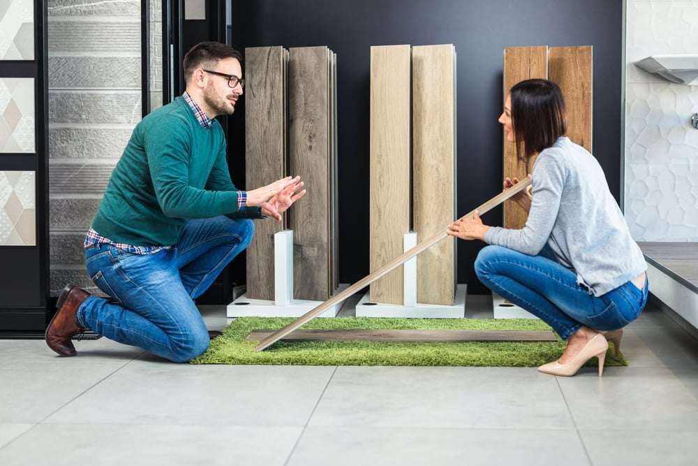 man and woman comparing engineered bamboo flooring and solid bamboo flooring