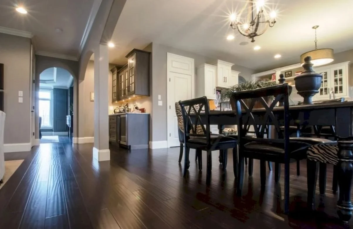 Kitchen with dark wood flooring and dining table