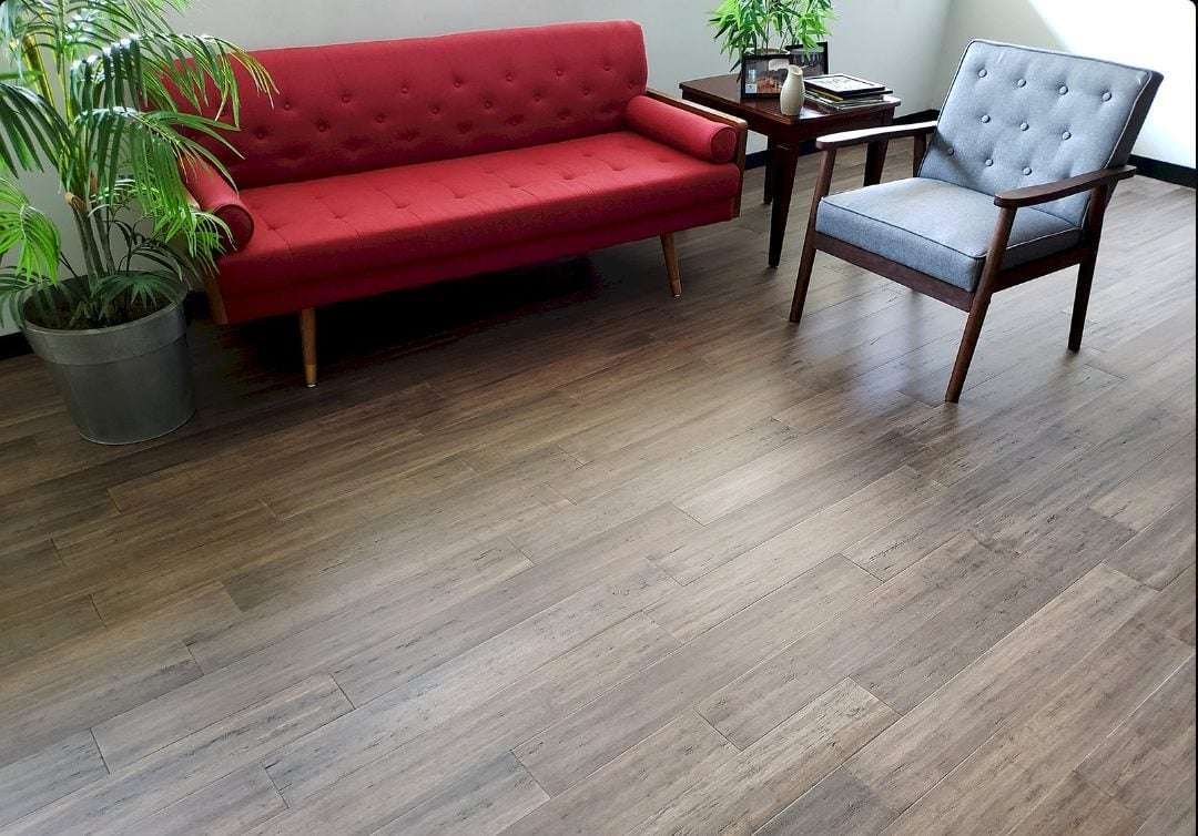 Room with brown wood floor and red couch