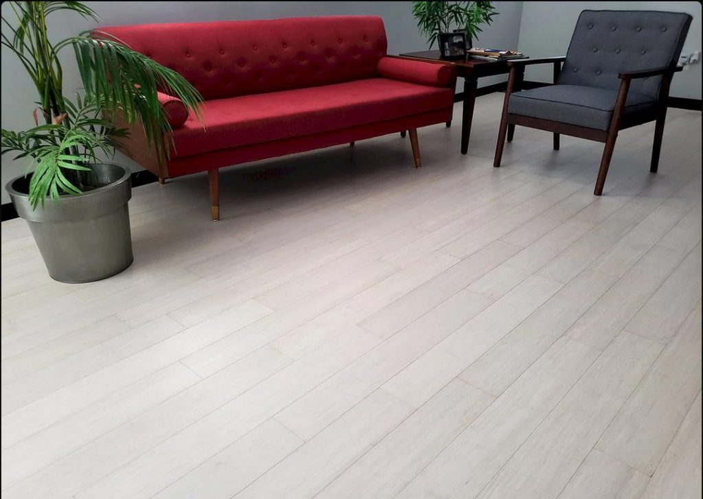 white bamboo flooring with red couch and blue chair