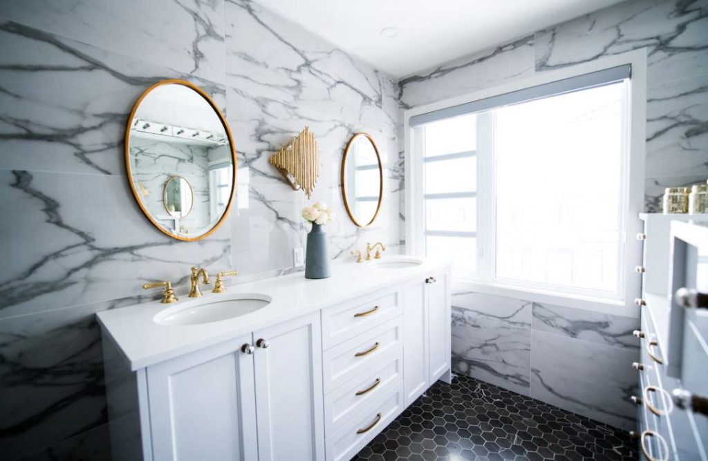 Modern, marble bathroom with natural lighting.