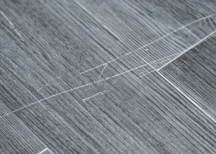 Close up of grey flooring with scratches