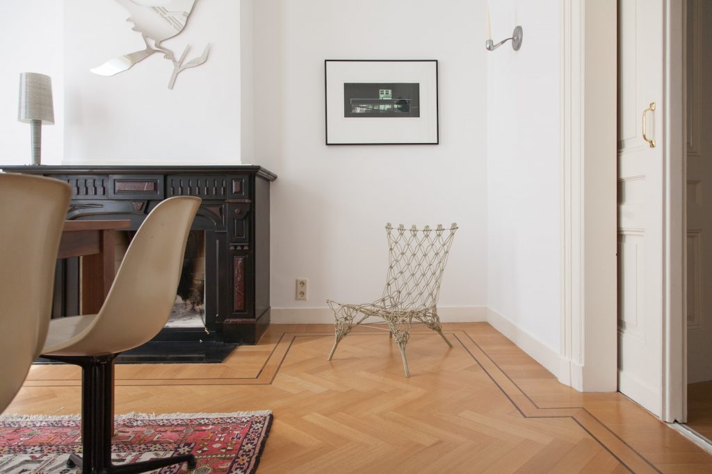 A stylish chair is featured on a patterned bamboo floor. In addition to being the most durable flooring, bamboo flooring like this brings traditional beauty into any home. 