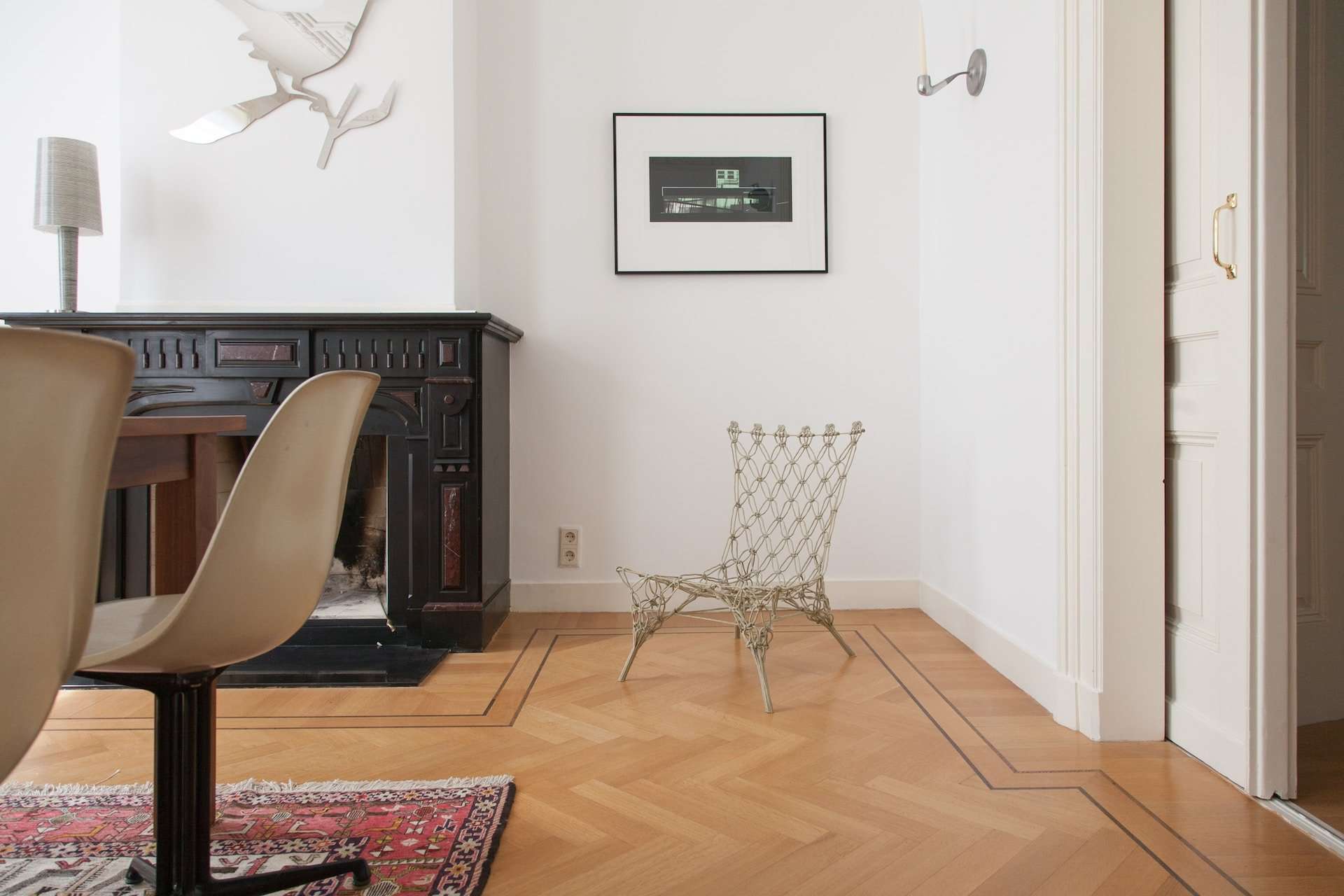 A stylish chair is featured on a patterned bamboo floor. In addition to being the most durable flooring, bamboo flooring like this brings traditional beauty into any home.